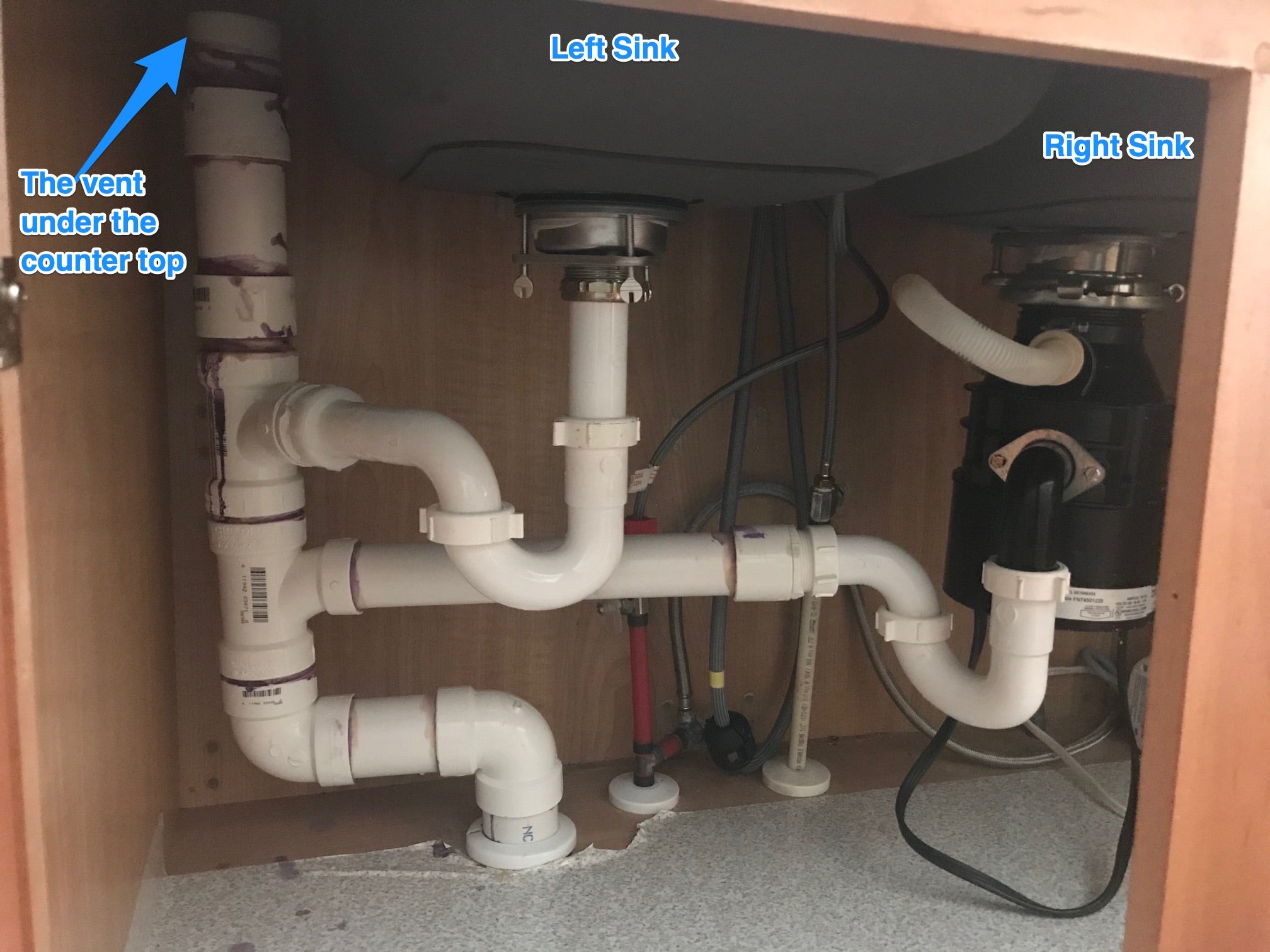 plumbing in kitchen sink with a vent